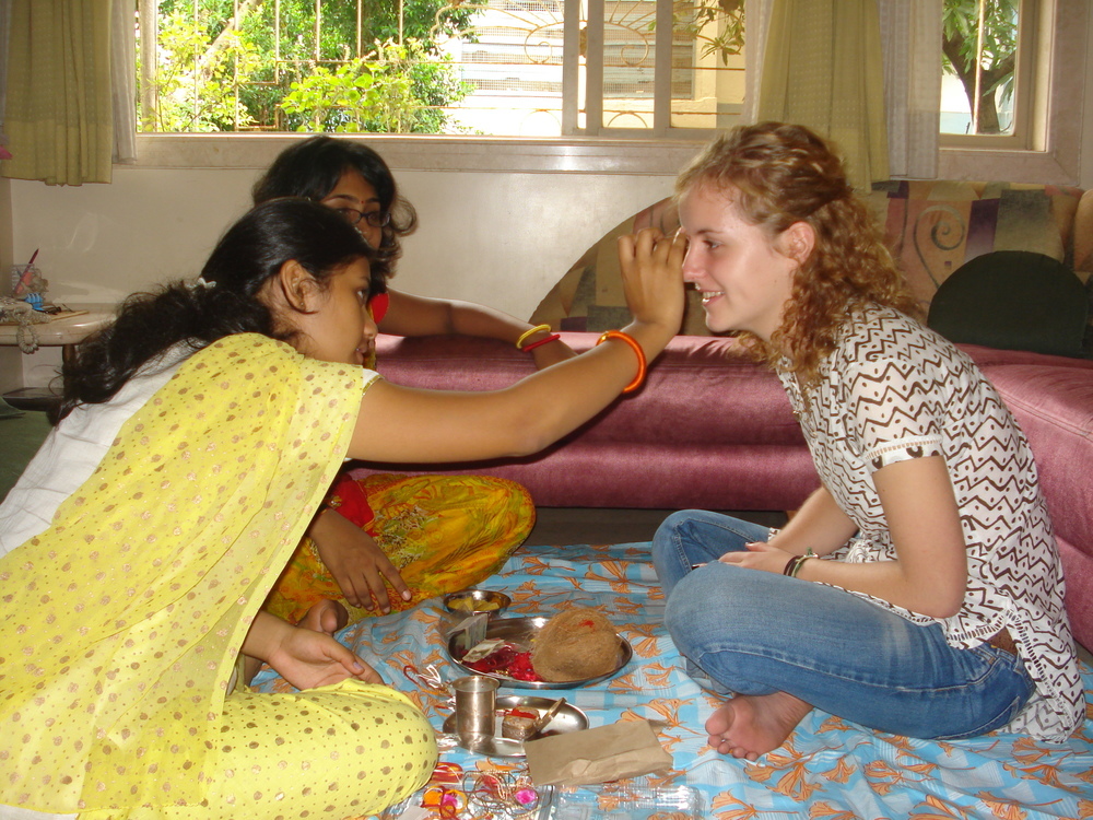 Linda bekommt von ihrer Freundin einen Segenspunkt auf die Stirn getupft